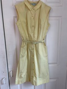 Adorable vintage 50s/60s button down summer dress.  Despite being in not great condition (several marks pictured), it's still so cute! Could probably improved with the right care/products. Sold as is. Measurements taken flat: Waist: 13" Pit to pit: 17" Waist to hem: 20" Top of neck to waist: 16" Shoulder to shoulder: 15" Vintage A-line Dress With Buttons, 1950s A-line Dress With Buttons, Retro Cotton Vintage Dress For Daywear, Vintage Sleeveless Buttoned Dress, Vintage Sleeveless Dress With Buttons, Retro A-line Dress With Button Closure, Knee-length Cotton Vintage Dress, Classic Cotton Vintage Dress For Spring, Sleeveless Vintage Dress With Buttons