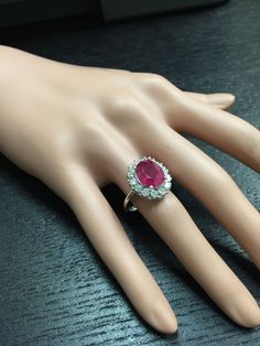 6.15 Carats Impressive Natural Red Ruby and Diamond 14K White Gold Ring Total Red Ruby Weight is: Approx. 5.15 Carats Ruby Measures: Approx. 11.00 x 9.00mm Natural Round Diamonds Weight: Approx. 1.00 Carat (color G-H / Clarity SI1-SI2) Ring total weight: Approx. 6.0 grams Disclaimer: all weights, measurements and colors are approximate and may vary slightly from the listed dimensions or as seen in the image. All pictures are magnified to show the smallest of details. Please, refer to the item de Classic Pink Cluster Ring For Formal Occasions, Gia Certified Platinum Ruby Ring, Gia Certified Fine Jewelry Ruby Ring In Platinum, Gia Certified Platinum Ruby Ring In Fine Jewelry, Luxury Ruby Cluster Ring, Red Cluster Ring With Brilliant Round Cut, Classic Red Oval Diamond Ring, Red Cluster Ring With Brilliant Cut, Exquisite Gia Certified Ruby Diamond Ring