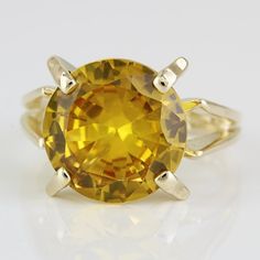 Vintage 10k Yellow Gold Citrine Gemstone Solitaire Cocktail Ring This Ring Is Made Of 10 Karat Yellow Gold & Features A Large Yellow Gemstone In The Center. The Vibrant Stone Is Held By Large, Angled Prongs That Connect To A Similarly Designed Ring Band That Complements The Stone's Style. "10k" Is Stamped Onto The Ring's Band. This Ring Can Be Resized By Any Qualified Jeweler. Size: 6 (Resizable) Width: 12.25mm Top X 2.45mm Bottom Metal: 10 Karat Yellow Gold Weight: 3.28 Dwt / 5.10 Grams Gemstone: Citrine (12.25mm) 799188-1 *E-Haa 14k Gold Yellow Rings With Accent Stones, Yellow Gold Jewelry With Round Accent Stones, Gold Citrine Jewelry With Center Stone, Classic Yellow Gold Jewelry With Topaz, 14k Gold Yellow Jewelry With Accent Stones, Yellow Gemstone With Center Stone As Gift, Yellow Gemstones For Wedding, Formal Yellow Jewelry With Accent Stones, Topaz Ring With Yellow Sapphire And Accent Stones