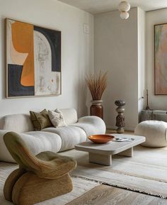 a living room filled with furniture and art