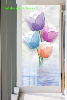 three colorful flowers are in front of a glass door with water and clouds behind them