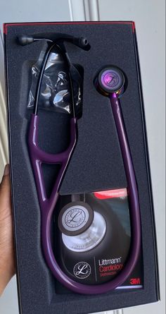 a purple stethoscope in a black box