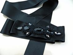 Black crystal sash, black belt for wedding dress, black satin belt for women, crystal belt, embroidered belt women, wedding belt ribbon.Hand embroidered belt with crystals on satin ribbon. An elegant accessory suitable for embellishing an evening dress or an unconventional wedding dress. Each of my creations is handmade after a careful study of shapes and colors. A unique piece created just for you!Length: 78.74 inchIt will be sent in a gift box.For any information do not hesitate to contact me! Luxury Black Embroidered Belt, Elegant Black Party Belt, Formal Black Embroidered Belt, Elegant Adjustable Sash For Formal Occasions, Elegant Black Belt For Evening, Elegant Adjustable Sashes For Formal Occasions, Elegant Formal Adjustable Sash, Elegant Formal Adjustable Sashes, Elegant Ribbon Sashes As Gifts