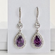 I've created these luxury purple amethyst cubic zirconia bridal tear drop earrings in rhodium plated brass setting. Earrings feature a large teardrop with pear cut purple amethyst cubic zirconia center surrounded by tiny round zirconia crystals. Teardrop dangles from a round cubic zirconia connector and zirconia detailed ear wire. Total length of the earrings is 5 cms. For matching necklace click: https://www.etsy.com/listing/465785454/purple-amethyst-cubic-zirconia-bridal?ref=shop_home_active_2 Purple Crystal Earrings For Wedding, Purple Bridal Earrings With Matching Set, Elegant Purple Drop Earrings, Elegant Purple Drop Crystal Earrings, Elegant Purple Cubic Zirconia Crystal Earrings, Elegant Purple Crystal Earrings, Elegant Lavender Crystal Dangle Earrings, Elegant Lavender Crystal Earrings For Wedding, Formal Lavender Amethyst Earrings