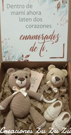 a crocheted teddy bear sitting in a box