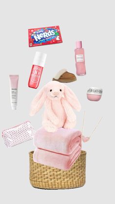 a pink stuffed animal sitting on top of a basket filled with cosmetics and other items