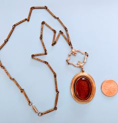 This is a beautiful necklace and pendant. I'm not sure what era it's from, but the chain, which has very intricate details etched in, and pendant are old. The clasp, however, is new. Victorian Filigree Metal Necklaces, Victorian Filigree Metal Necklace, Gold Locket Necklace In Copper, Victorian Copper Necklace As Gift, Victorian Style Copper Necklace As Gift, Victorian Copper Necklace For Gift, Ornate Locket Necklace For Formal Occasions, Vintage Engraved Chain Necklace For Gift, Antique Gold Necklaces With Vintage Charm