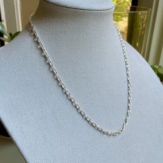 Are you looking for a timeless statement necklace for someone special? Do you need a sturdy sterling silver chain for a special pendant? This simple yet elegant handcrafted oval chain will last forever and would make the perfect gift. And it costs a fraction of silver chains that come in a blue box and a bow! Here are the details: This beautiful necklace starts off as sterling silver wire and a clasp and was transformed into a tiny oval link chain...each link measuring about 3mm x 6mm and the completed length is about 21 inches long. All of the links were individually formed, cut and soldered - which is tricky with links this small! This item was handmade by Will Macy in Corvallis, OR. This item is ready to ship. If you need a different length, please message us and we can make any length Minimalist Oval Silver Chain Jewelry, Minimalist Oval Jewelry With Silver Chain, Silver Oval Pendant Necklace With Sterling Clasp, Silver Oval Pendant Necklace With Sterling Silver, Sterling Silver Chain Necklace With Oval Pendant, Classic Silver Chain Necklace With Oval Pendant, Everyday Silver Chain Necklace With Round Pendant, Timeless Sterling Silver Chain Necklace In Silver, Elegant Oval Sterling Silver Chain Necklace