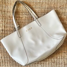 Ever Skincare By Stella & Dot Branded Tote Bag. White Vegan Leather Exterior W/ Black Trim, Reversible To Gold Interior. No Hardware Or Closure. 9”W X 6”H Detachable Wristlet W/ Zipper Closure Included. Wristlet Is Also Reversible: White On One Side W/ Gold Magnolia Print On The Other. Please Note Although Never Used, The Gold Lining Interior Has Puckered / Delaminated In Places But There Are No Tears In The Finish. 22”W (At Top; 14-1/2”W At Bottom) X 12”H X 6”D. 9” Drop Handles. Smoke Free, Pet Magnolia Print, Branded Tote Bags, Vegan Leather Tote Bag, Vegan Leather Tote, Gold Interior, Stella And Dot, 6 D, Black Trim, Leather Tote Bag