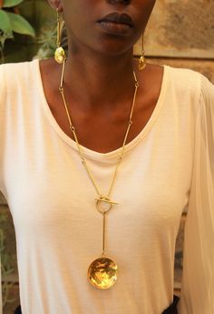 Handmade in Nairobi , Kenya! Crafted with brass pendants. Clasp is located in the front. Necklace length- 40.5cm Earrings length- 7cm SHIPPING Shipping is done via DHL Express, 3-7 days delivery, Add multiple items to your cart and pay shipping for one item ONLY! Brass Medallion Necklace With Chain As Gift, Brass Medallion Necklace As Gift, Metal Long Dangle Necklace As A Gift, Metal Dangle Long Necklace For Gift, Dangle Long Metal Necklace As Gift, Dangle Long Necklace As Gift, Metal Long Necklace With Round Pendant As Gift, Gold-tone Brass Jewelry With Detachable Pendant, Adjustable Brass Jewelry With Toggle Clasp