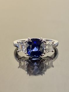 "DeKara Designs Collection Beautiful Modern/Art Deco Ceylon Blue Sapphire and Diamond Ring Metal- 90% Platinum, 10% Iridium Stones- Genuine Cushion Cut Ceylon/Sri Lanka Royal Blue Sapphire 2.87 Carats. Two Trapezoid Cut Diamonds G-H Color VS1 Clarity 0.93 Carats. Size-6. FREE SIZING Entirely Handmade, Classic and Timeless Art Deco Inspired Ceylon Cushion Cut Royal Blue Sapphire Diamond Engagement Ring. This ring is out of this world with the center Ceylon Sapphire being exceptional in quality, c Emerald Cut Sapphire Blue Jewelry, Blue Sapphire Emerald Cut Jewelry, Emerald Cut Blue Sapphire Jewelry, Blue Emerald Cut Sapphire Jewelry, Blue Sapphire Three Stone Ring With Diamonds, Gia Certified Blue Sapphire Ring In Platinum, Gia Certified Cushion Cut Sapphire Jewelry, Cushion Cut Diamond Sapphire Wedding Ring, Wedding Sapphire Ring With Diamond And Cushion Cut