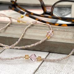 Sparkly eyeglass necklace chain made with Preciosa Czech crystal seed beads in golden tones with delicate multicolor flashes, featuring gold and pink cubic zirconia beads. Unique and bohemian this necklace chain will definitely create a unique look.   This eyeglass lanyard is made on strong quality beading wire with gold plated wire guardians that protect the quality eyeglass holder grips. The necklace is ended with spring clasps that hold the eyeglass grips and they can be easily removed to tra Adjustable Crystal Necklaces With Colorful Glass Beads, Gold Beaded Glass Crystal Necklaces, Gold Glasses Chains With Colorful Glass Beads, Adjustable Gold Crystal Glass Necklace, Bohemian Gold Glasses Chains With Colorful Beads, Handmade Gold Glass Beads, Bohemian Gold Beaded Glass Necklaces, Adjustable Gold Beaded Necklace With Czech Glass, Gold Beaded Glasses Chains