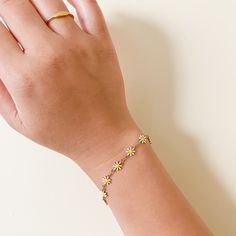 Put a spring in your step with the Daisy Bracelet! Fun and cheerful, this flower-inspired jewelry is perfect for brightening up any everyday look! Material: 18k gold plated on stainless steel Stone: White Enamel, Yellow Enamel Daisy Bracelet, Inspired Jewelry, White Enamel, Everyday Look, 18k Gold, Daisy, Gold Plate, Plating, Bracelet