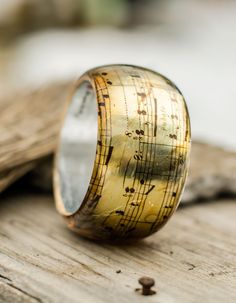 Resin Bangle Bracelet, Music Bracelet, Vintage Music Notes Bangle That is a copy of an old vintage music note paper. The music notes flow all around the bangle, so you may feel the Symphony when you wear it.There is a silver foil from the inside of the bangle that makes the note paper more shiny. Wide Thick bangle - Height of the bangle - 4.7cm/1.85inches Our jewelry always comes with a special handmade packing for a present and a greeting card that can have a text given by you. That is free of Music-themed Band Jewelry As Gift, Music-themed Band Jewelry Gift, Music-themed Bracelet Jewelry Gift, Vintage Music Notes, Music Bracelet, Avant Garde Jewelry, Resin Bangles, Transparent Resin, Gift For Music Lover