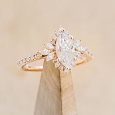 an engagement ring with a pear shaped diamond