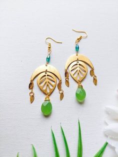 This nature inspired, gemstone earrings feature: ~ Faceted green jade teardrop beads ~ Green glass beads ~ Brass findings: Leaves and crescent ~ Gold toned ear wire hooks ~ non tarnish gold over brass craft wire ~ It is 3.5 inches long. Thanks for shopping with JewelryByOri! Handmade Green Teardrop Earrings, Green Teardrop Brass Jewelry, Green Teardrop Earrings For Jewelry Making, Green Teardrop Drop Earrings For Jewelry Making, Green Leaf-shaped Earrings For Pierced Ears, Bohemian Green Teardrop Earrings With Ear Wire, Bohemian Jade Earrings, Green Drop Bohemian Jewelry, Green Bohemian Drop Jewelry