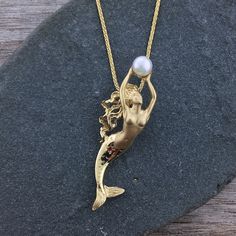 This is a truly stunning, three dimensional, solid 14 karat gold mermaid pendant. The mermaid is holding a high luster pearl. The finest quality 14 karat gold is used to handcraft this unique, ocean inspired, distinctive piece. Dimensions: 1 11/16 in. / 42mm High It is available as a pendant only or with an 18" heavy 1 Mermaid Inspired Jewelry, Greece Project, Yellow Mermaid, Water Temple, Nautical Necklace, Diamond Band Engagement Ring, Nautical Earrings, Mermaid Core, Diamond Engagement Band