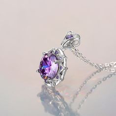 Sparkling and elegant, this purple necklace is perfect for that special evening out. Created in sterling silver, it features a round cut stone sparking at its center, while additional round stones line the sterling silver settings for extra shimmer. An imaginative look you'll adore, this necklace is unsurpassed with magnificence and sparkle.Carat Weight: 8.5 ctStone Size: 11 mmStone Type: Jeulia® StoneNumber of Stones: 1 Stone Shape: RoundStone Color: Amethyst PurpleCarat Weight: 2.658 ctStone S Amethyst Flower, Purple Necklace, White Necklace, Amethyst Purple, Necklace Online, Sterling Silver Necklace, Quality Jewelry, Diamond White, Sterling Silver Necklaces