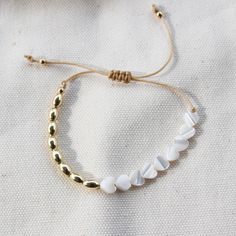 D E T A I L S: • 18k Gold Filled • Cord free to adjust (8 - 12") …………………………………. M A T E R I A L S: • Beads (3mm) • Heart (5cm) • Beige cotton cord • All sourced from USA White Jewelry With Adjustable Cord For Everyday, White Beaded Bracelets With Adjustable Chain, Adjustable White Beaded Bracelet, White Jewelry With Adjustable Cord, Dainty White Jewelry With Sliding Knot, Velvet Clutch, Ball Bracelet, Cotton Cord, Canvas Bag