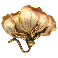 An art nouveau enamel Orchid pendant-brooch. An exceptional pendant-brooch in the shape of an orchid flower, created in America during the Art Nouveau period, back in the 1900. This brooch is a little gem and has been carefully crafted in solid yellow gold of 14 karats with satin frosted finish and embellished with applications of opalescent polychromed glass enamel. The brooch is fitted at the reverse with a hinged pin bar and a security hook to be wear. Can be also displayed in a chain as pictured. The enamel work is exceptional and meticulous, far exceeding the details of the fibers and veins of the leaves. It is a little jewel with exquisite and exceptional details. Art Nouveau Jewelry The Art Nouveau jewelry was created in France between about 1895 and 1910. This is a style of jewelry Closet Art, Bijoux Art Nouveau, Brooch Art, Nouveau Jewelry, Fantasy Closet, Art Nouveau Jewelry, Enamel Brooch, Deco Jewelry, Enamel Flower