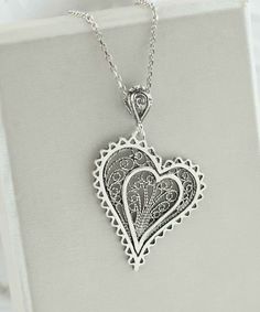 Introducing our Handcrafted Filigree Art Asymmetric Heart Figured Women's Silver Pendant Necklace! This stunning piece features a unique design with an asymmetric heart-shaped pendant, measuring 1.65 inches in height and 1.05 inches in width, suspended from a 20-inch silver chain. Expertly crafted with filigree art, this necklace is a beautiful addition to any jewelry collection. It comes with a silver polish cloth and a luxurious gift box, making it the perfect gift option for Mother's Day, ann Bohemian Heart Pendant Charm Necklace Gift, Bohemian Silver Heart Charm Necklaces, Metal Heart Pendant Necklace, Bohemian Silver Heart Charm Necklace, Unique Heart Pendant Wedding Jewelry, Unique Heart Pendant Jewelry For Wedding, Unique Metal Jewelry With Heart Charm, Heart Pendant Necklace As Gift, Metal Heart Pendant Necklace As Gift