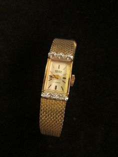 Art deco charming, Gruen Percision 17 Jewels, 10 K RGR Bezel Stainless Back, golden wrist watch,  Pat. Pen. 1/20 10 KT GF Kreisler U.S.A. noted on band, watch, in etching & engraving. Hand winding, and is working, Excellent presentation. A 6.5" around the wrist, 1" x half inch, with six small symmetric diamonds or white stones. Golden Wrist Watch, Modern Clock, Square Watch, White Stone, Wrist Watches, Jewellery And Watches, Halloween Shopping, Wrist Watch, Jewelry Watches