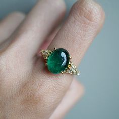 Read about our payment plans before proceeding.This is what dreams are made of. This emerald ring features an insanely gorgeous deep green natural cabochon emerald stone, embellished with 57 natural white diamonds with details like phoenix wings. A classy and sleek ring to treasure forever. Handcrafted in your choice of 14K yellow gold, rose gold, and white gold. The emerald shown is the exact same emerald you will receive. 14K solid gold Natural 12*9mm natural cabochon emerald. Approx. 2.8ct~. Phoenix Wings, Rings Unique, Dream Engagement, Dream Engagement Rings, Wedding Rings Unique, Emerald Stone, Emerald Ring, White Diamonds, Deep Green