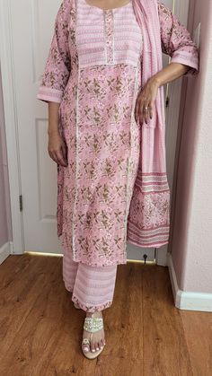 A 100% pure cotton pink printed palazzo suit with dupatta is ideal for summer season. Beautiful print enhance the beauty of this suit . The sleeves are 3/4 and palazzo pant has elastic and belt. This beautiful soft cotton suit is good for summer parties , casual  and special occasions. Floral Print Traditional Wear For Spring Festivals, Floral Print Traditional Wear For Festive Spring, Floral Traditional Wear For Festive Spring Season, Pink Bohemian Palazzo Set With Printed Motifs, Bohemian Long Sleeve Floral Print Sharara, Traditional Floral Print Sharara For Spring, Pink Floral Print Palazzo Set For Navratri, Floral Print Straight Kurta For Eid, Long Sleeve Kurta With Floral Print For Diwali