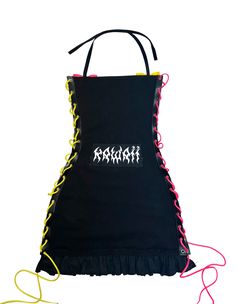 a black apron with yellow and red laces on the sides, attached to a string