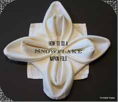 how to do a snowflake napkin fold on a black tablecloth with the words, how to do a snowflake napkin fold