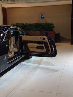 the interior of a car with its doors open in a showroom at an airport