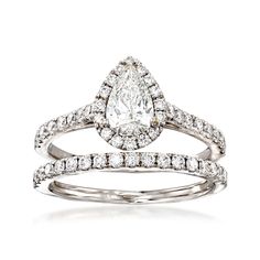 an engagement ring set with a pear shaped diamond in the center and side stones on each band