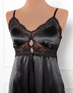 A sweet but sexy top drawer favorite with satin, lace and decorative bows. Elegant Black Lace Top With Built-in Bra, Black Lace Party Tops, Black Lace Tops For Party, Lace Top With Built-in Bra For Night Out, Night Out Delicate Lace Camisole, Delicate Lace Camisole For Night Out, Black Sleeveless Delicate Lace Top, Black Satin Cami Top, Black Sleeveless Camisole With Lace Patchwork