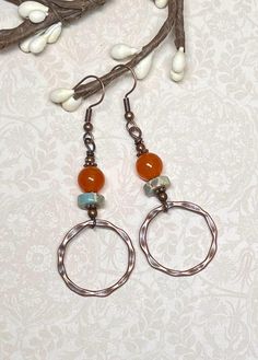 These boho everyday earrings, perfect not only for fall, but anytime of year, were created using orange dyed Quartzite gemstone beads, Serpentine Jasper heishi beads in light turquoise with splashes of orange and beige, small daisy spacer beads, and antique copper hammered connector hoops. Total length of earrings, including the ear wire, is approximately 2-1/2".  The hoops measure slightly less than 1" x 1". For matching bracelet, click on the link below: https://www.etsy.com/listing/1775405734/boho-gemstone-layered-bracelet-bohemian?click_key=dd7cc051989c2a01f33517f997db305a15f4ae31%3A1775405734&click_sum=2e4d6686&ref=shop_home_active_1&frs=1&sts=1 Thank you for shopping with The Lucie Collection! Bohemian Wire Wrapped Hoop Earrings For Everyday, Bohemian Hoop Earrings With Natural Stones For Jewelry Making, Bohemian Copper Hoop Earrings As Gift, Everyday Bohemian Copper Jewelry, Rust Color Dangle Earrings With Ear Wire, Rust Dangle Earrings With Ear Wire, Bohemian Rust Earrings With Ear Wire, Rustic Handmade Hoop Earrings, Nickel Free Orange Earrings For Everyday