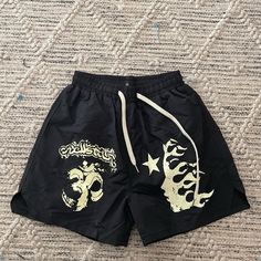 Hellstar Shorts | Bought These Thinking They Were More Of A Cotton Material Type Shorts But They Are More Of A Swimming Trunks Material | Never Worn | Comes With Hellstar Bag Edgy Black Shorts For Streetwear, Casual Black Beach Bottoms, Black Beachwear Shorts With Elastic Waistband, Black Bottoms With Pockets For Beach Season, Black Beach Bottoms With Pockets, Black High-waist Bottoms With Letter Print, Black High Waist Bottoms With Letter Print, High Waist Black Bottoms With Letter Print, Black Beach Shorts With Pockets