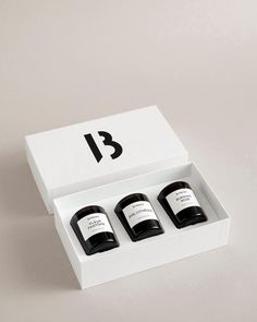 three bottles in a white box with black numbers