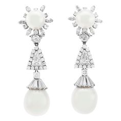 The earrings are finely crafted in platinum with four pearls two on top and two on the low level of the drop. With diamonds weighing approximately total of 3.00 carat. Luxury Platinum Pearl Earrings For Formal Occasions, Classic White Gold Pearl Earrings, Classic Platinum Pearl Earrings For Formal Occasions, Classic Silver Platinum Pearl Earrings, Luxury Platinum Pearl Earrings, Luxury Platinum Pearl Earrings For Wedding, Luxury White Pear-shaped Pearl Earrings, Elegant Platinum Pearl Earrings For Formal Occasions, Classic Evening Pearl Earrings, Pear-shaped