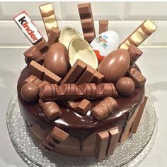 a chocolate cake topped with lots of different types of candies on top of it