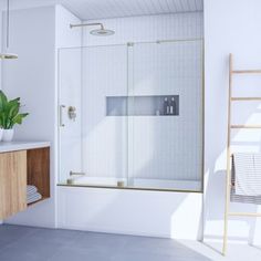 a bathroom with a sink, mirror and shower stall in the corner next to a ladder