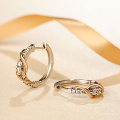 As a couple in love, you are also best friends. Holidays, birthdays, anniversaries, and other special occasions become a celebration of your enduring love and friendship. The beautiful two tone design meaningfully represents the dual nature of your bond. Smaller stones above and below the center stones and a graceful swirling ribbon of polished rose gold tone complete the lovely linear look.Carat Weight: 1.7 ctStone Size: 2.5,1.5 mmNumber of Stones: 20 Stone Shape: RoundStone Color: Diamond Whit Rose Gold Huggie Hoop Earrings For Anniversary, Elegant Valentine's Day Hoop Earrings, Small Hoop Rose Gold Earrings For Anniversary, Silver Hoop Earrings With Elegant Design As Gift, Silver Hoop Earrings With Elegant Design, Elegant Hoop Earrings For Mother's Day, Elegant Hoop Earrings For Anniversary And Mother's Day, Small Hoop Earrings For Anniversary On Valentine's Day, Rose Gold Hoop Earrings With Diamond Accents For Wedding