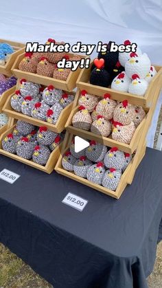 a table topped with trays filled with stuffed animals next to a sign that says market day is best day