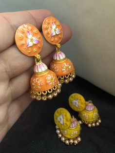 Very stylish and vibrant colors meena work jhumka earrings. Stunningly made designs with all the love and hand painted meena kari, perfect match for a perfect outfit! Grab all the lovely new arrivals we have! Colors : yellow, orange In stock and ready to wear. Yellow Round Meenakari Jewelry, Traditional Meenakari Dangle Jhumkas, Temple Jewelry Jhumkas As A Gift, Gift Temple Jewelry Jhumkas, Hand Painted Enamel Jewelry For Wedding, Hand Painted Enamel Jewelry For Weddings, Hand Painted Enamel Wedding Jewelry, Traditional Enamel Jewelry With Matching Earrings, Traditional Multicolor Hand Painted Jewelry