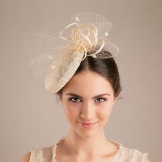 The millinery wedding hat in natural colour of sinamay is trimmed with a veiling bow for a touch of wedding tradition. With a voluminous bun or an elegant updo sitting glamorously under a this hat, your style will be striking and sophisticated. The bridal hat makes a civil ceremony feel like the special and unique moment.  Pictured in natural sinamay colour.  If you prefer this hat in more understated version, choose the colour matching your hair colour.  Available in various colour, please, see Elegant Beige Straw Hat With Structured Crown, Elegant Cream Party Veil, Cream Mini Hat For Summer Ceremony, Cream Mini Hats For Summer Ceremonies, Cream Mini Hat For Summer Ceremonies, Summer Ceremony Cream Mini Hats, Adjustable Fascinator For Wedding, Sinamay Fascinator With Short Brim For Church, Church Fascinator With Short Brim In Sinamay