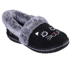 Cuddle up with your four-legged bestie in purrfect comfort with Skechers Hands Free Slip-ins BOBS from Skechers Too Cozy - Meow PJ's. This casual slipper features a vegan suede upper with an embroidered 3-D Black Cat face design, faux-fur trim, and a cushioned Skechers Memory Foam footbed. For every BOBS purchase, a donation is made to animals in need. | Skechers Women's Slip-ins: BOBS Too Cozy - Meow PJ's Shoes | Medium Width | Skechers Hands Free Slip-ins for an easy fit | Skechers Memory Foam cushioned comfort footbed | Crafted with 100% vegan materials | Vegan suede upper | Embroidered 3-D Black Cat face design with a faux-fur trim | Midsole with 'Meow Meow Meow' print all the way around | Slip-on casual comfort slipper design | Indoor/outdoor flexible traction outsole | BOBS from Skec Black Cat Face, Faux Fur Top, Skechers Bobs, Black Slippers, Designer Slippers, Shoe Black, Casual Slippers, Skechers Women, Clean Shoes