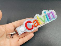 "Holographic, Shinny Vinyl embroidered name Tag/ keychain/made with  the highest quality material. Perfect to apply to a whole range of applications like, Key, backpack, Lunch bag, lunch box, Sport bags, Library totes, diaper bags, pouches, and some zippers.  Bag tags are made from a vinyl material with a swivel lobster clasp or traditional split ring  Please see the attached photos for  font styles and thread colors.   Letters will generally be about 1-1.5\" in height based on capitalization an Personalized Multicolor Keychains For Everyday Use, Customized Multicolor Keychains For School, Personalized Multicolor Fun Badge Holder, Everyday Multicolor Personalized Keychains, Box Sport, Name Tag Keychain, Personalized Multicolor Keychains, Kids Bag Tags, Personalized Multicolor Lanyards