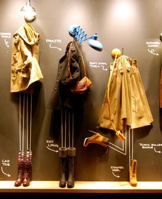 the coat rack has many coats and boots on it