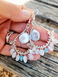 The earrings are made of beautiful natural moonstones dangle  on silver hooks and natural  pearl in the middle of the hook. The blue crystal of apatite between dangling moonstones add the sofisticated look. Complex in color - moonstones and pearls have iridescent colors. Perfect pear of earrings for your wedding gown.  The size of the pearl is 12 mm in diameter.  Length ( with ear hooks) is a little over 2 1/2 inches. The ear wires are silver plated. Please visit my Policies page for shipping and additional information: http://www.etsy.com/shop/BridalBay/policy Arrives in a gift box for easy gift-giving. Bohemian Sterling Silver Jewelry With Pearl Drop, Bohemian Sterling Silver Pearl Drop Jewelry, Silver Teardrop Chandelier Earrings With Natural Stones, White Pearl Earrings With Natural Stones For Wedding, White Natural Stone Pearl Earrings For Wedding, Handmade Sterling Silver Dangle Bridal Earrings, Teardrop Pearl Earrings With Natural Stones, Bohemian Silver Chandelier Earrings With Pearl Drop, Silver Pearl Earrings With Natural Stones As Gift