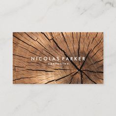 a wooden business card with the name nicholas parker