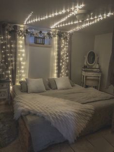 a large bed with lights on the ceiling