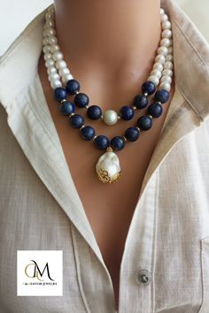 A timeless accessory that embodies natural beauty, our elegant Pearl and Lapis Lazuli Necklace combines lustrous freshwater pearls, known for their lustrous and iridescent appeal, with the deep blue appeal of genuine Lapis Lazuli gemstones. Handmade with love and attention to detail, this stunning necklace exudes a sense of opulence and elegance. Classic Long Necklace For Weddings, Elegant Double Strand Pearl Pendant Jewelry, Handmade Double Strand Pearl Jewelry, Elegant Double Strand Necklace For Anniversary, Elegant Double Strand Necklace For Weddings, Elegant Handmade Double Strand Crystal Necklaces, Elegant Handmade Double Strand Crystal Necklace, Elegant Pearl Pendant Beaded Necklace As Gift, Double Strand Fine Jewelry For Wedding